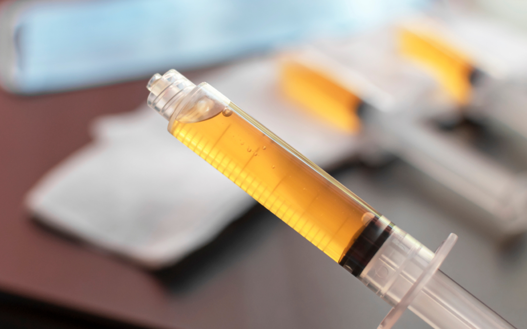 A yellow syringe is sitting on the table.