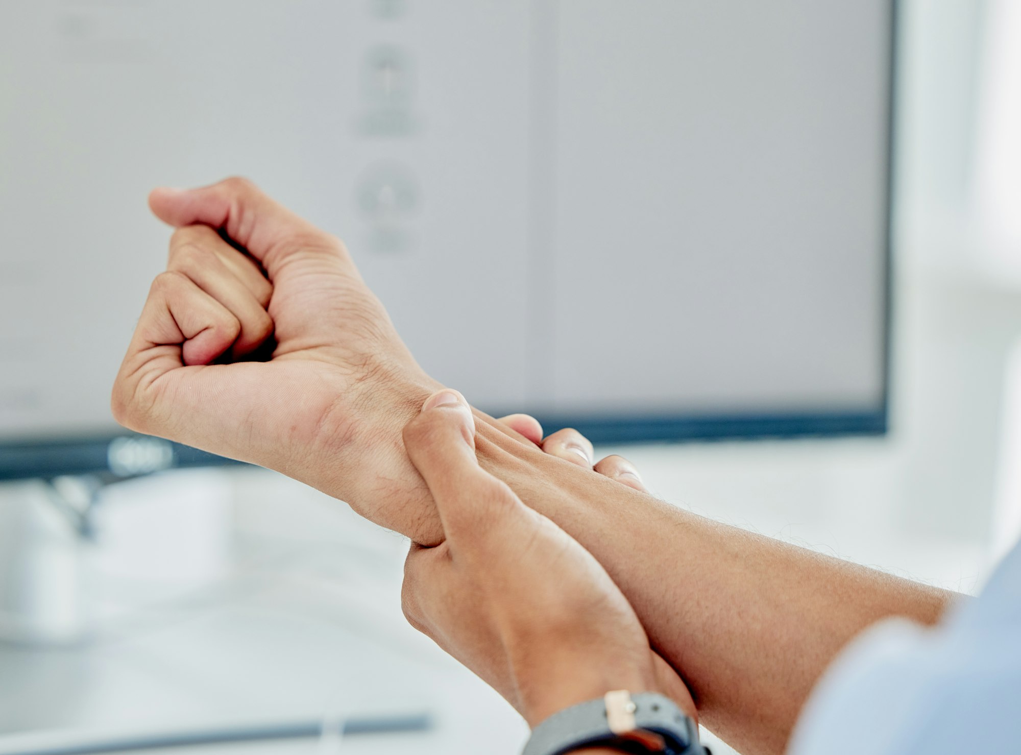 A person holding their hands up to the side of his face.