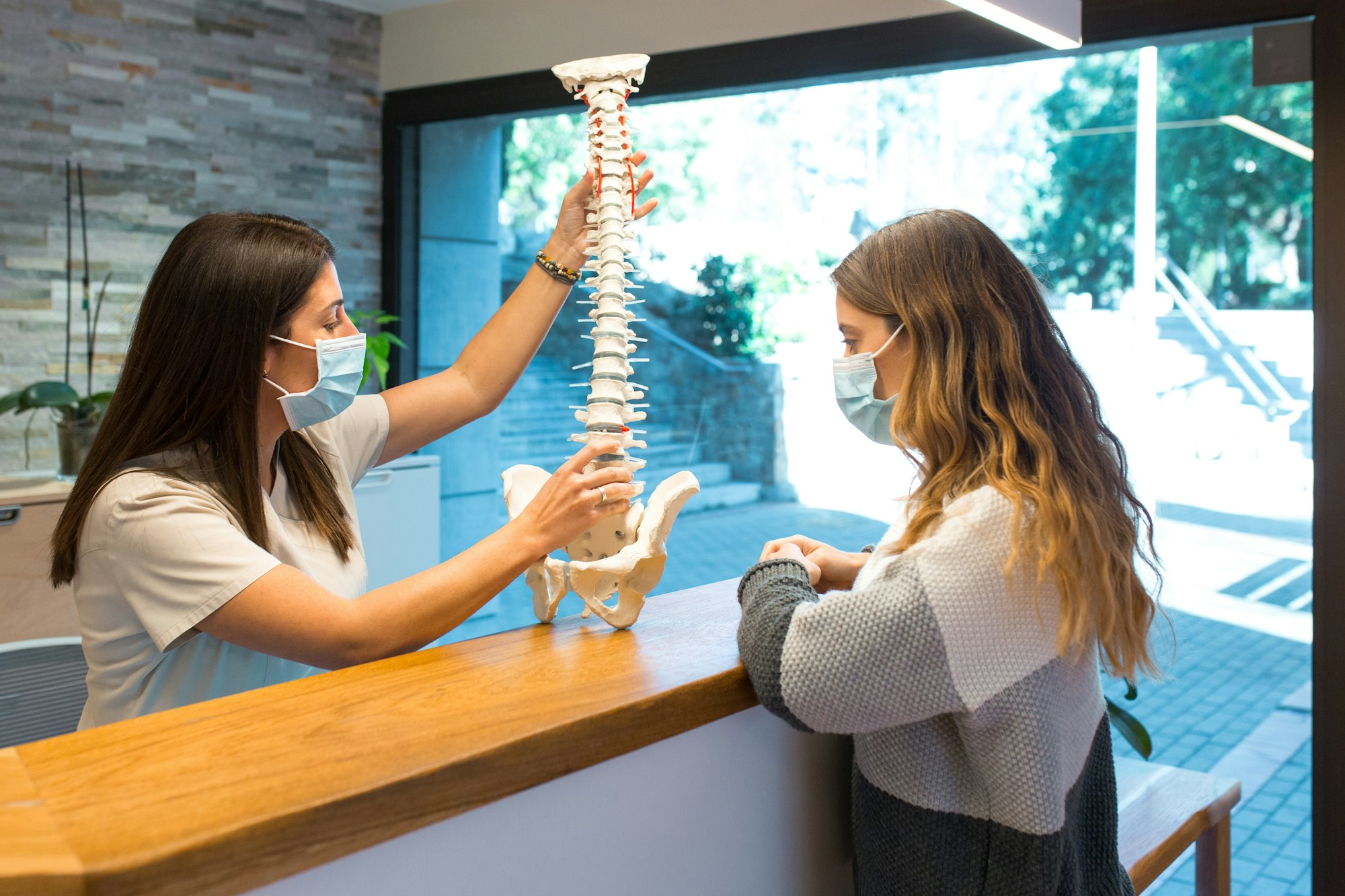 A woman is standing behind the counter of a dental office.