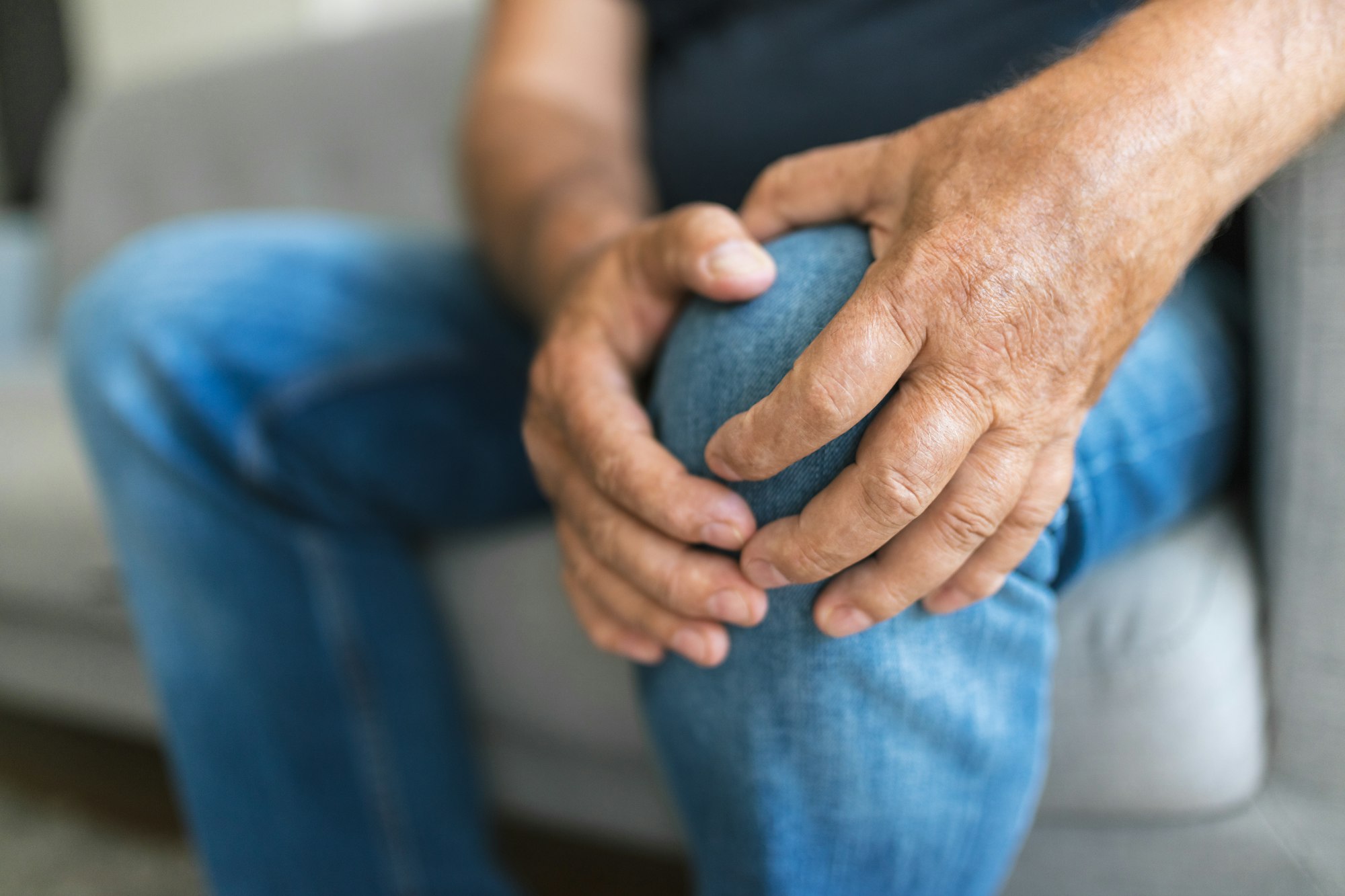 A man with his hands on the knee