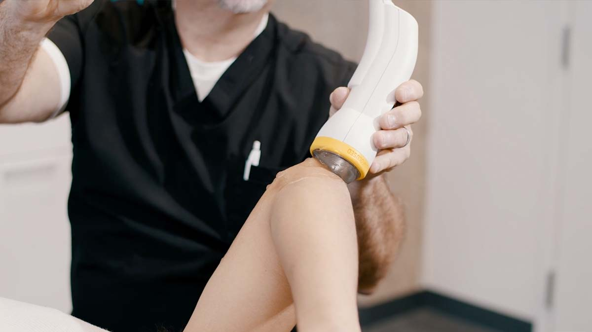 Patient receiving SoftWave shockwave therapy for chronic back pain at Charleston Pain Relief Center